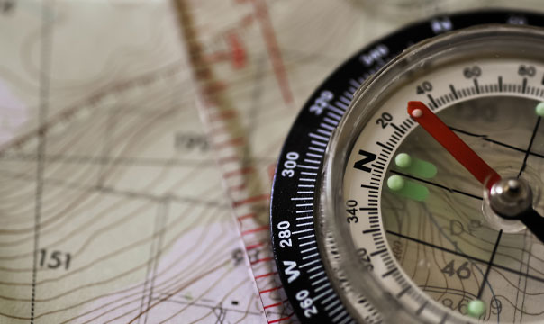 Closeup photo of a compass and map